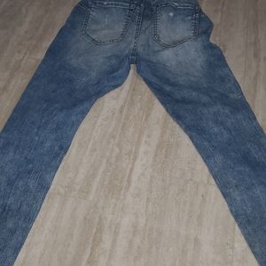 Blue ripped jeans with patches